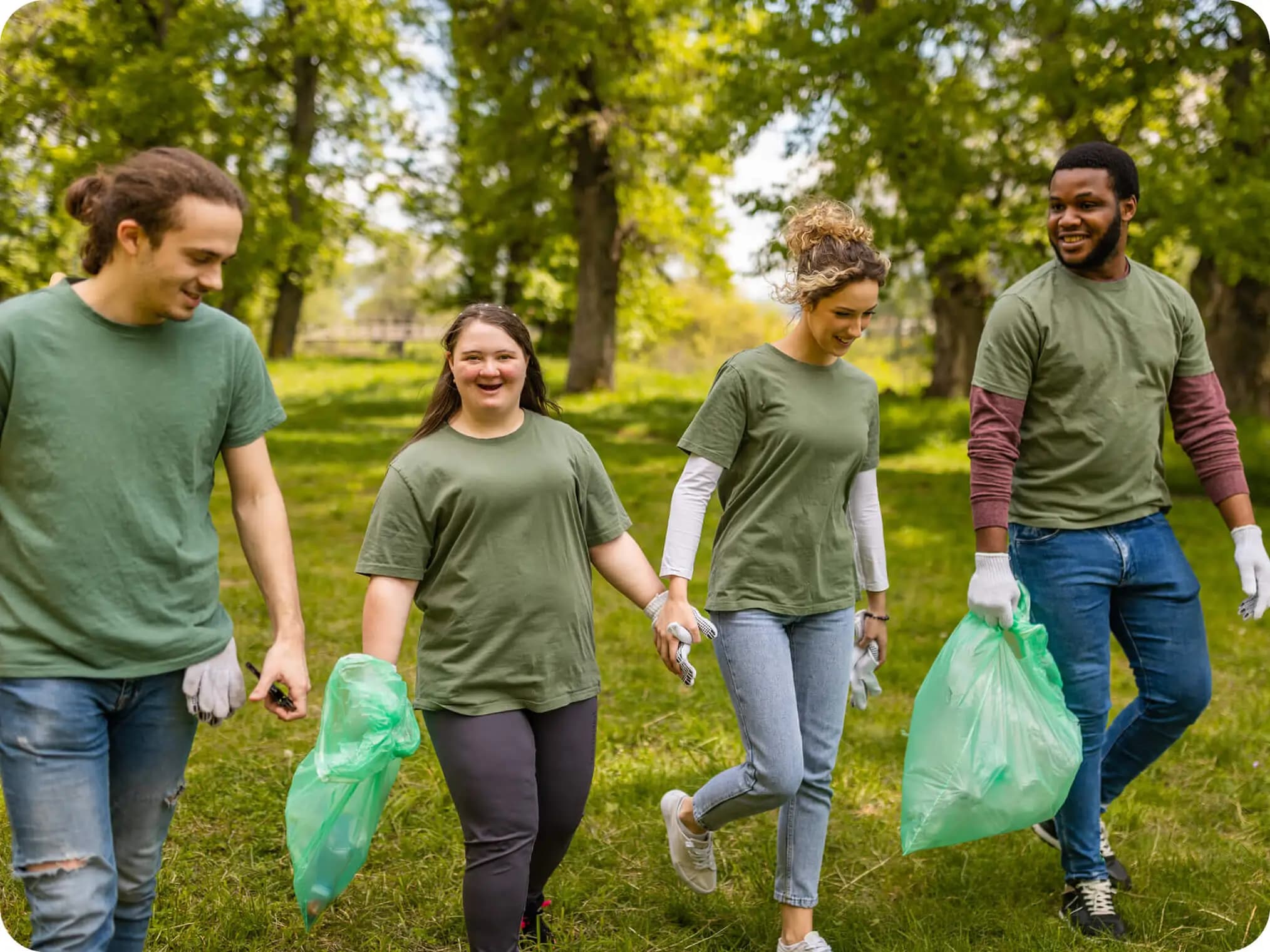 Two smiling volunteers working together outdoors.